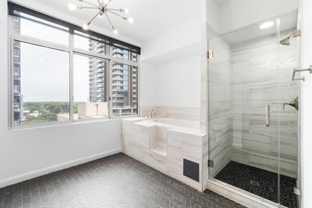 54 Rainey St Unit 1018, Austin, TX 78701 - bathroom with a bath, a stall shower, and a chandelier