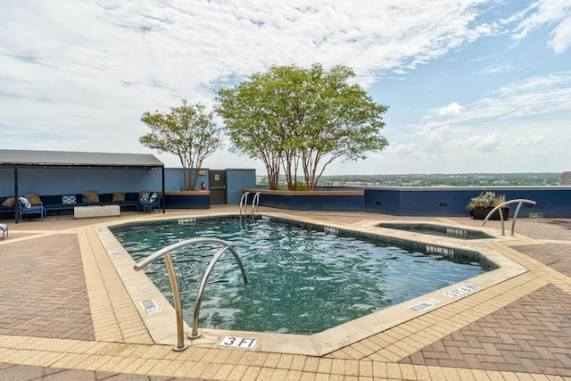54 Rainey St Unit 1018, Austin, TX 78701 - community pool featuring a hot tub, a patio, and an outdoor living space