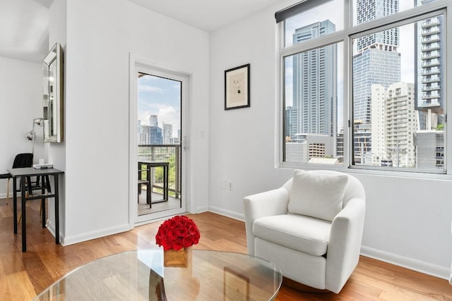 54 Rainey St Unit 1018, Austin, TX 78701 - sitting room featuring a city view, wood finished floors, and a desk