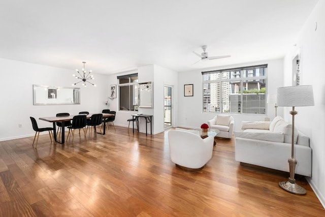54 Rainey St Unit 1018, Austin, TX 78701 - living room featuring wood finished floors, a ceiling fan, and a chandelier