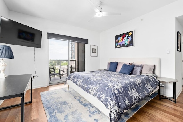 54 Rainey St Unit 1018, Austin, TX 78701 - bedroom with access to outside, wood finished floors, and ceiling fan