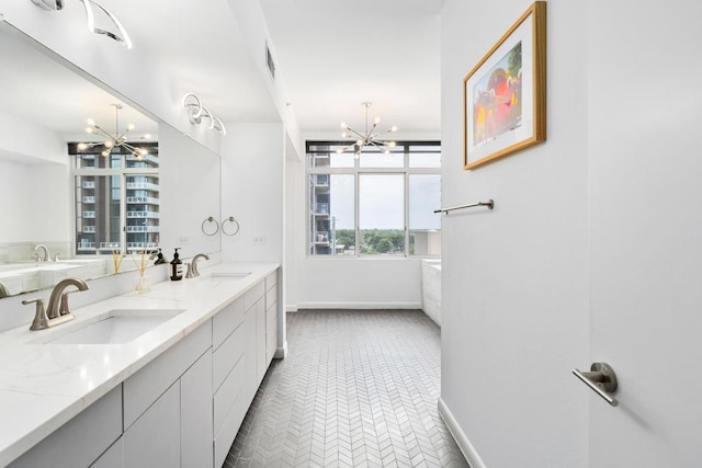 54 Rainey St Unit 1018, Austin, TX 78701 - bathroom featuring a chandelier and double vanity