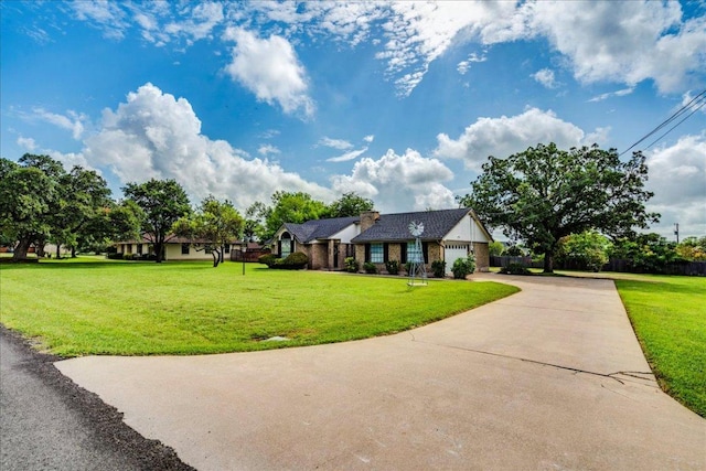 206 Live Oak Dr, Mountain City, TX 78610 - view of front of house featuring driveway, an attached garage, and a front yard