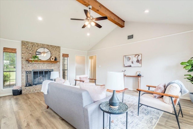 206 Live Oak Dr, Mountain City, TX 78610 - living room with light wood-style floors, beam ceiling, a fireplace, ceiling fan, and high vaulted ceiling