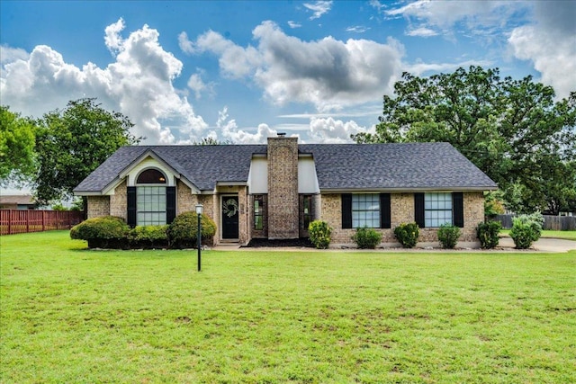206 Live Oak Dr, Mountain City, TX 78610 - view of front of home featuring a chimney, roof with shingles, and brick siding