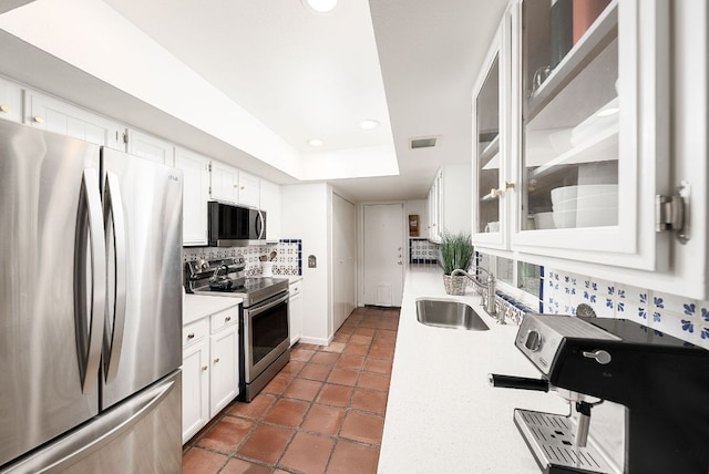 3617 Las Colinas Dr Unit B, Austin, TX 78731 - kitchen with appliances with stainless steel finishes, backsplash, light countertops, white cabinets, and recessed lighting