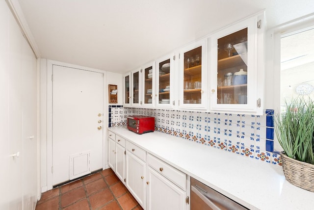 3617 Las Colinas Dr Unit B, Austin, TX 78731 - kitchen featuring light countertops, white cabinetry, glass insert cabinets, decorative backsplash, and stainless steel dishwasher