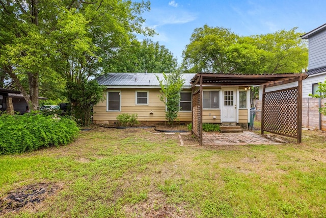 5513 Jim Hogg Ave, Austin, TX 78756 - back of house featuring entry steps, a yard, a metal roof, and crawl space