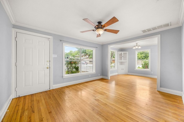 5513 Jim Hogg Ave, Austin, TX 78756 - foyer entrance with ceiling fan, light wood-style floors, a chandelier, and ornamental molding