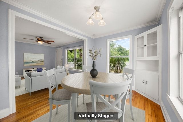 5513 Jim Hogg Ave, Austin, TX 78756 - dining space featuring light wood-style flooring, ornamental molding, and a ceiling fan