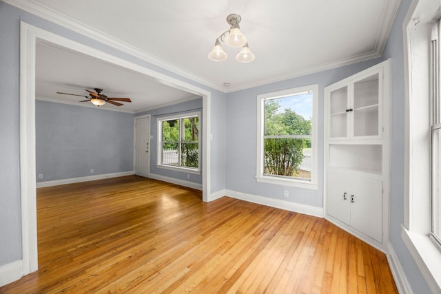 5513 Jim Hogg Ave, Austin, TX 78756 - unfurnished room featuring light wood-style floors, ornamental molding, a chandelier, and a ceiling fan