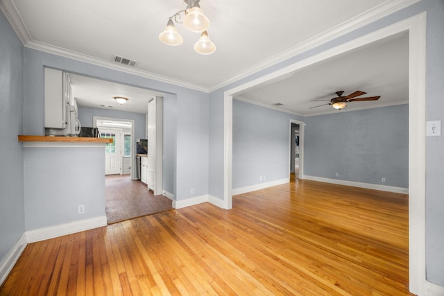 5513 Jim Hogg Ave, Austin, TX 78756 - spare room featuring light wood-style flooring, a ceiling fan, and ornamental molding