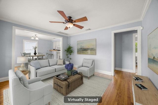 5513 Jim Hogg Ave, Austin, TX 78756 - living room with ceiling fan, wood finished floors, ornamental molding, and a chandelier
