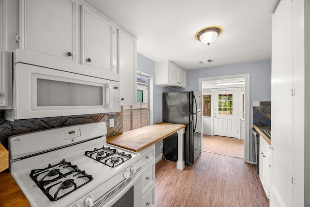 5513 Jim Hogg Ave, Austin, TX 78756 - kitchen featuring white appliances, light wood-type flooring, white cabinetry, and butcher block countertops