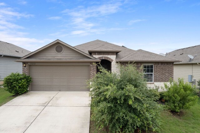 15212 Shell Bark Cv, Austin, TX 78724 - view of front of house featuring brick siding, concrete driveway, and a garage