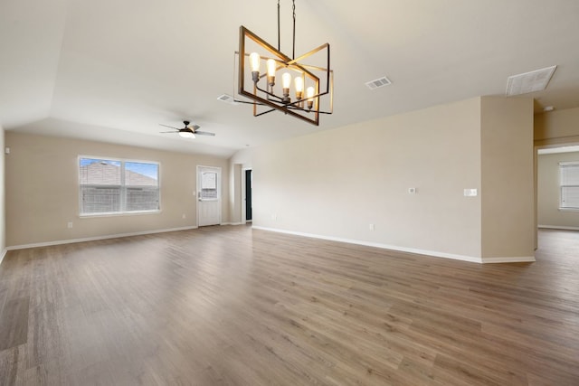 15212 Shell Bark Cv, Austin, TX 78724 - unfurnished living room with a ceiling fan, wood finished floors, and a chandelier
