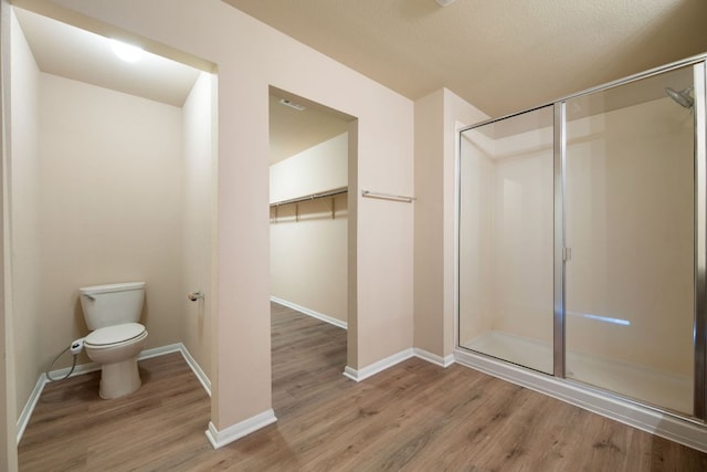 15212 Shell Bark Cv, Austin, TX 78724 - bathroom with a stall shower, wood finished floors, and a walk in closet