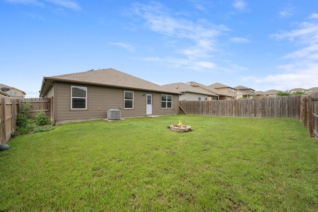 15212 Shell Bark Cv, Austin, TX 78724 - back of property featuring an outdoor fire pit and a fenced backyard