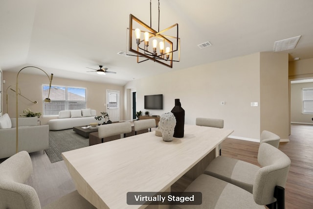 15212 Shell Bark Cv, Austin, TX 78724 - dining space with wood finished floors, a ceiling fan, lofted ceiling, and a chandelier