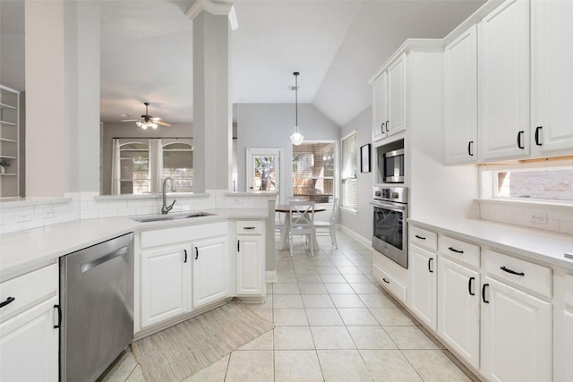 10408 Hansa Dr, Austin, TX 78739 - kitchen with appliances with stainless steel finishes, backsplash, lofted ceiling, light tile patterned floors, and white cabinets