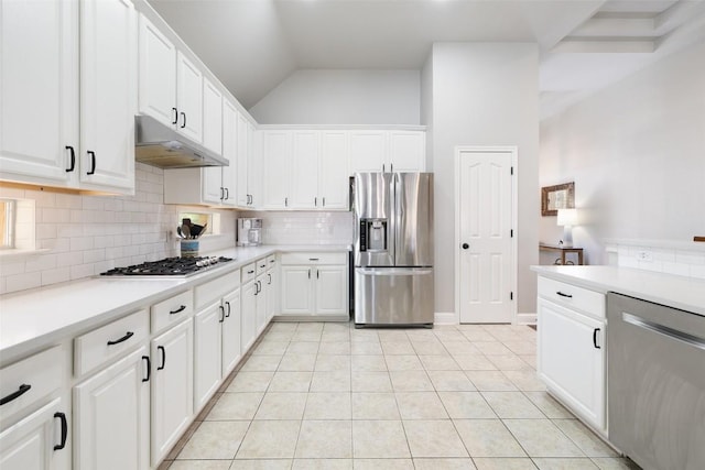 10408 Hansa Dr, Austin, TX 78739 - kitchen with stainless steel appliances, under cabinet range hood, tasteful backsplash, light countertops, and vaulted ceiling