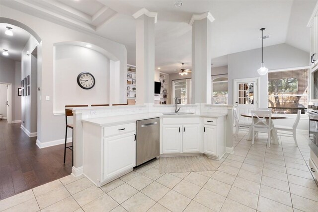 10408 Hansa Dr, Austin, TX 78739 - kitchen with stainless steel dishwasher, ceiling fan, light countertops, hanging light fixtures, and white cabinetry