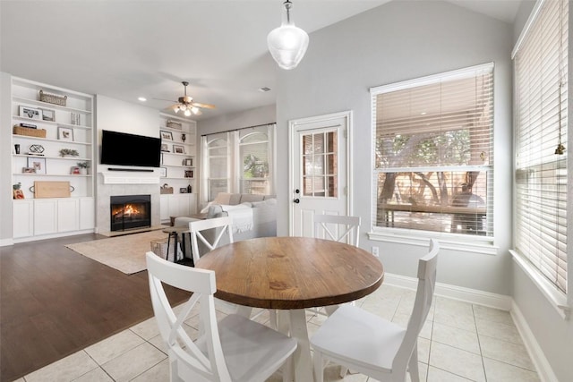 10408 Hansa Dr, Austin, TX 78739 - dining space with ceiling fan, plenty of natural light, a lit fireplace, and recessed lighting