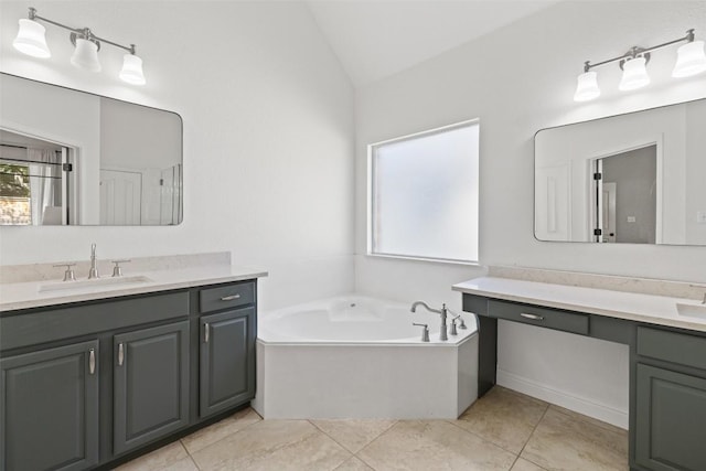 10408 Hansa Dr, Austin, TX 78739 - bathroom with lofted ceiling, two vanities, a garden tub, and tile patterned floors
