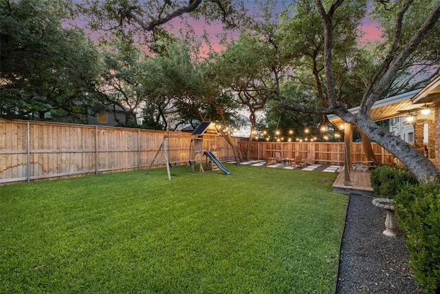 10408 Hansa Dr, Austin, TX 78739 - yard at dusk featuring a fenced backyard and a playground
