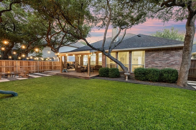 10408 Hansa Dr, Austin, TX 78739 - back of property with a wooden deck, brick siding, a shingled roof, and a chimney