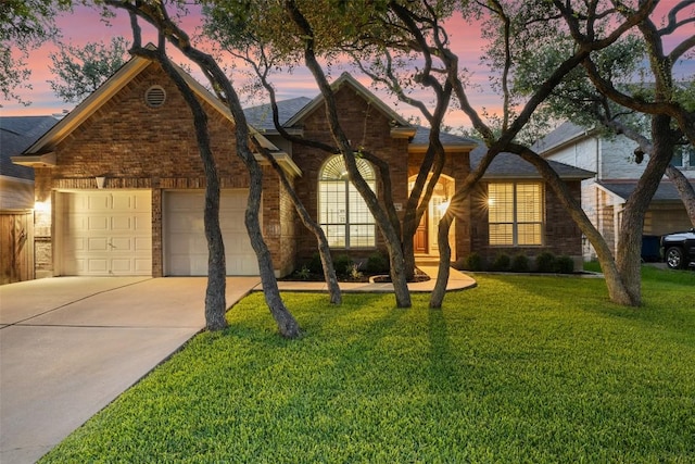 10408 Hansa Dr, Austin, TX 78739 - view of front facade featuring concrete driveway, a yard, brick siding, and a garage