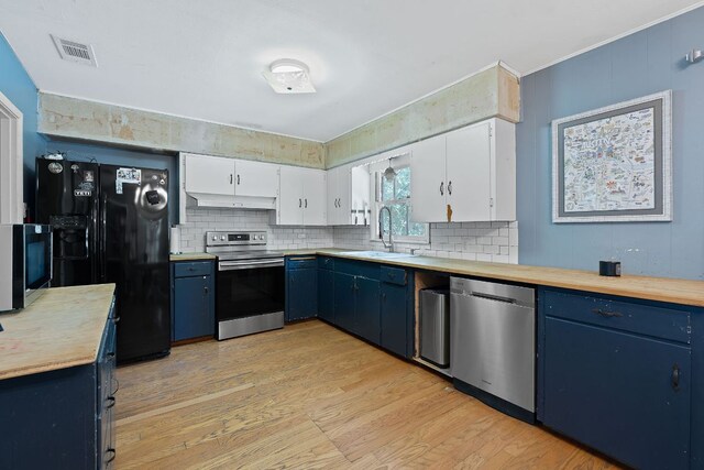 10000 Gail Rd, Austin, TX 78748 - kitchen with appliances with stainless steel finishes, blue cabinetry, under cabinet range hood, light wood-style flooring, and decorative backsplash