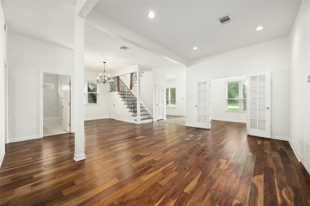 301 Crane St, Austin, TX 78734 - unfurnished living room featuring stairs, french doors, a chandelier, dark wood finished floors, and recessed lighting