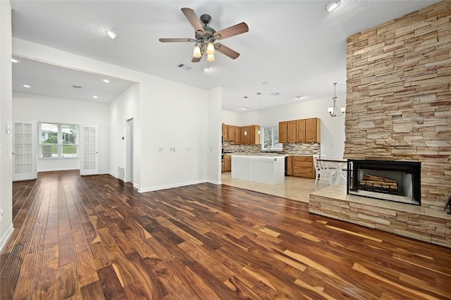 301 Crane St, Austin, TX 78734 - unfurnished living room featuring hardwood / wood-style flooring, a ceiling fan, a fireplace, and recessed lighting