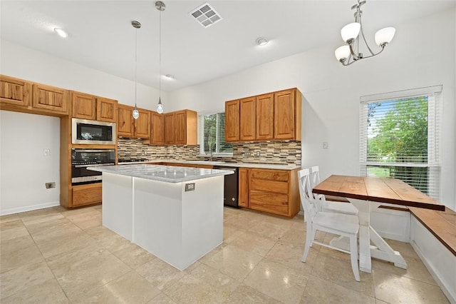 301 Crane St, Austin, TX 78734 - kitchen featuring appliances with stainless steel finishes, decorative backsplash, brown cabinetry, and light countertops
