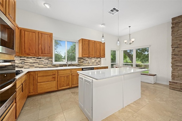 301 Crane St, Austin, TX 78734 - kitchen featuring stainless steel appliances, decorative backsplash, and light countertops