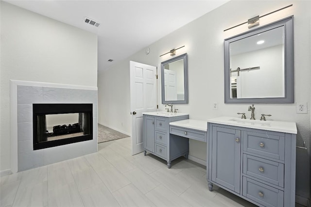 301 Crane St, Austin, TX 78734 - full bathroom featuring two vanities and a multi sided fireplace