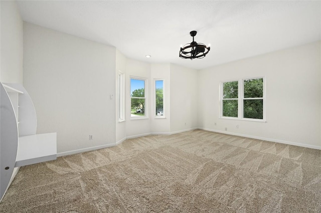 301 Crane St, Austin, TX 78734 - carpeted spare room featuring a chandelier and baseboards