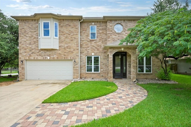 301 Crane St, Austin, TX 78734 - view of front facade featuring an attached garage, concrete driveway, a front yard, and brick siding