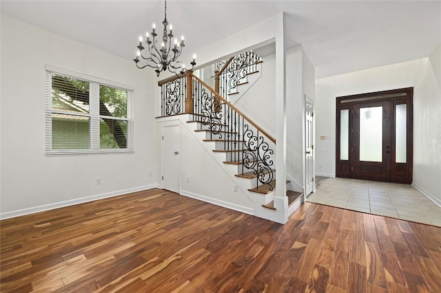 301 Crane St, Austin, TX 78734 - foyer featuring a chandelier, stairs, and wood finished floors