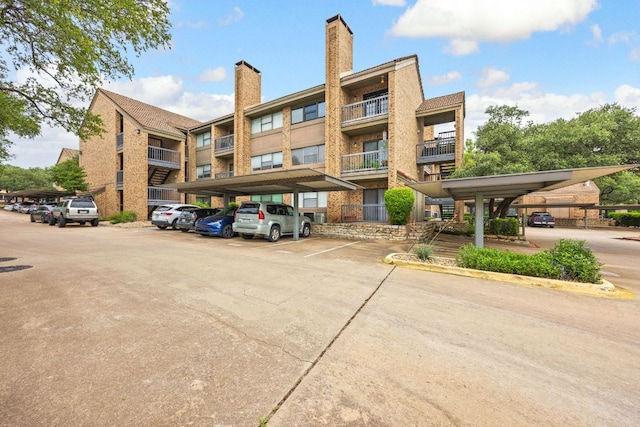 8888 Tallwood Dr Unit 1202, Austin, TX 78759 - view of property featuring covered and uncovered parking