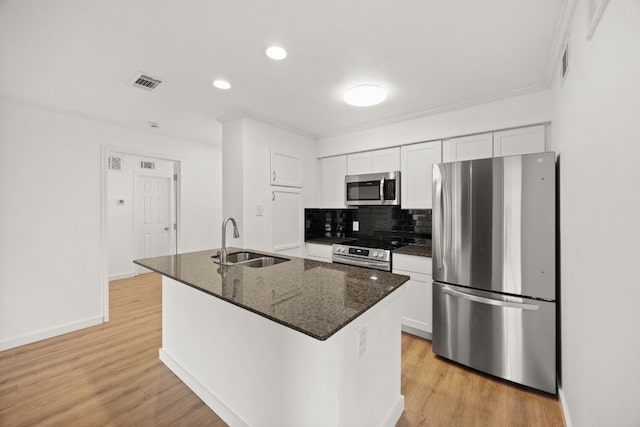 8888 Tallwood Dr Unit 1202, Austin, TX 78759 - kitchen featuring appliances with stainless steel finishes, white cabinetry, tasteful backsplash, light wood-style floors, and recessed lighting