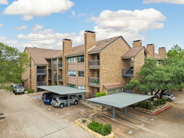8888 Tallwood Dr Unit 1202, Austin, TX 78759 - view of property with covered and uncovered parking