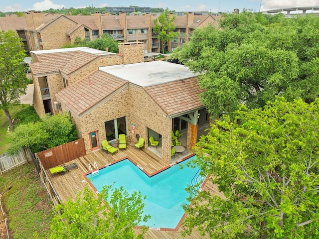 8888 Tallwood Dr Unit 1202, Austin, TX 78759 - rear view of property with a wooden deck, a residential view, and a tile roof