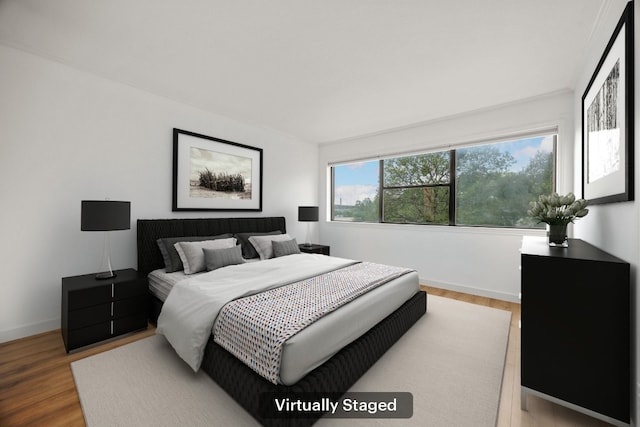 8888 Tallwood Dr Unit 1202, Austin, TX 78759 - bedroom with wood finished floors and baseboards