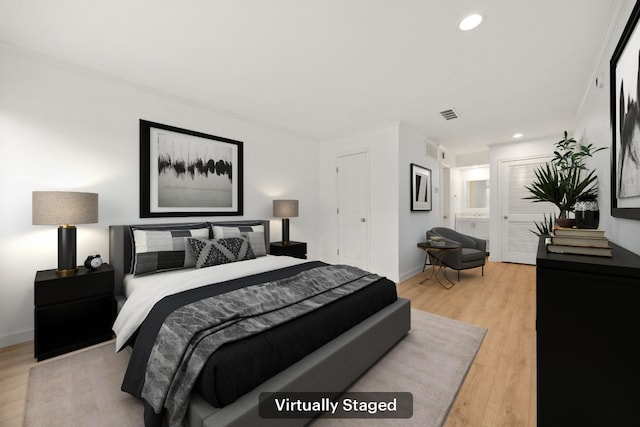 8888 Tallwood Dr Unit 1202, Austin, TX 78759 - bedroom with light wood-style flooring, recessed lighting, and ensuite bathroom