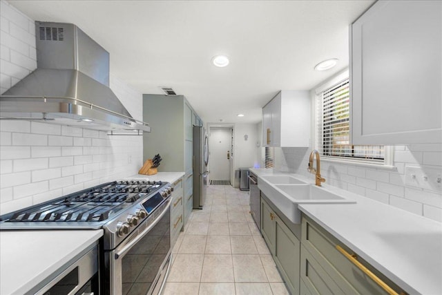 2616 Jefferson St Unit A, Austin, TX 78703 - kitchen featuring exhaust hood, appliances with stainless steel finishes, backsplash, light countertops, and recessed lighting