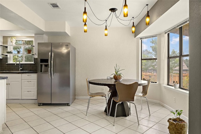 809 Windsor Rd, Round Rock, TX 78664 - dining area featuring healthy amount of natural light, a chandelier, and light tile patterned flooring
