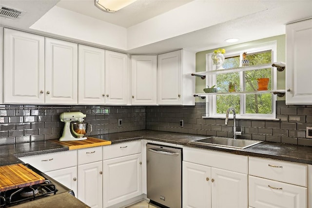 809 Windsor Rd, Round Rock, TX 78664 - kitchen with stainless steel dishwasher, white cabinetry, open shelves, and dark countertops