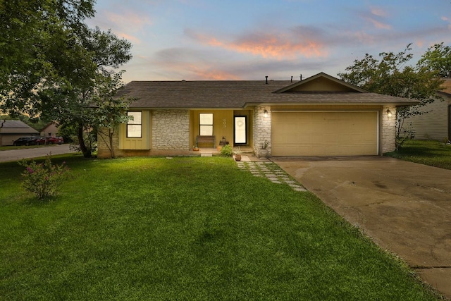 809 Windsor Rd, Round Rock, TX 78664 - ranch-style home featuring driveway, a garage, stone siding, a lawn, and roof with shingles